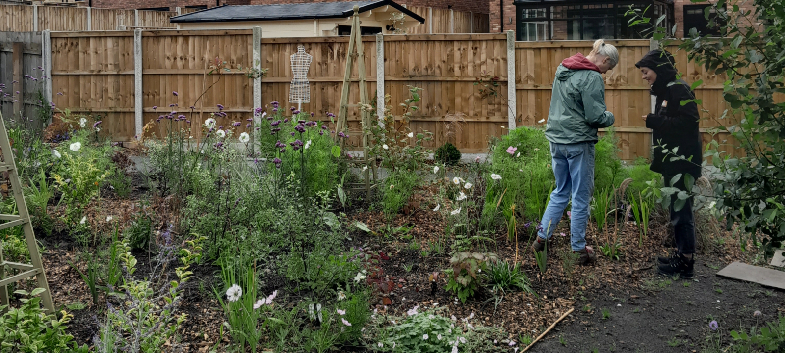 Two people at community garden developing as part of green spaces fund