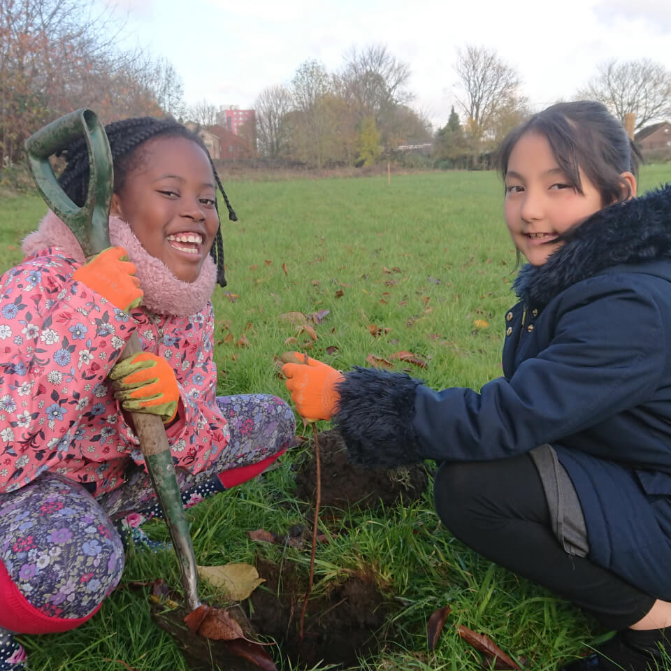 Children planting with spade