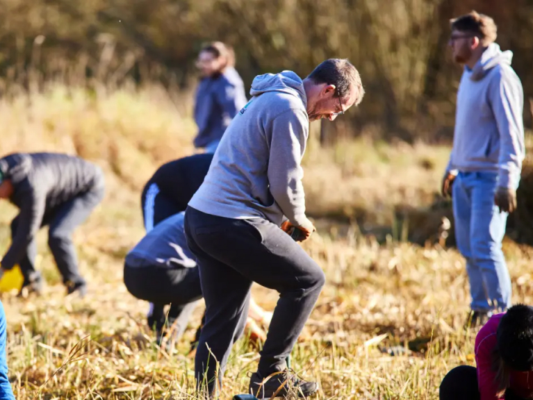 Man digging with a spade outside