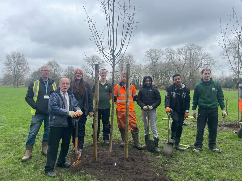 Group of global youth, City of Trees and councillor with newly planted tree