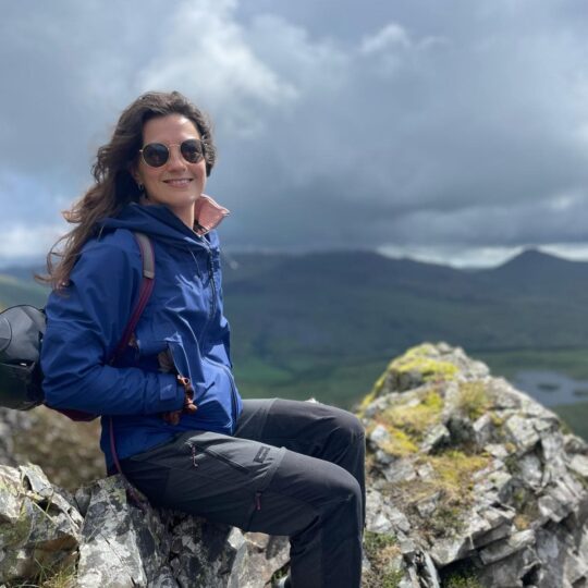 Team member smiling on mountain